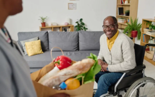 man-with-disability-getting-groceries-from-caregiv-2022-07-28-23-55-46-utc-1024×683